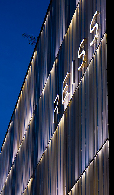 White lighting emphasises the design of the building at night. 