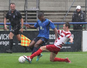 Kingstonian defender takes out Ola in the pouring rain.