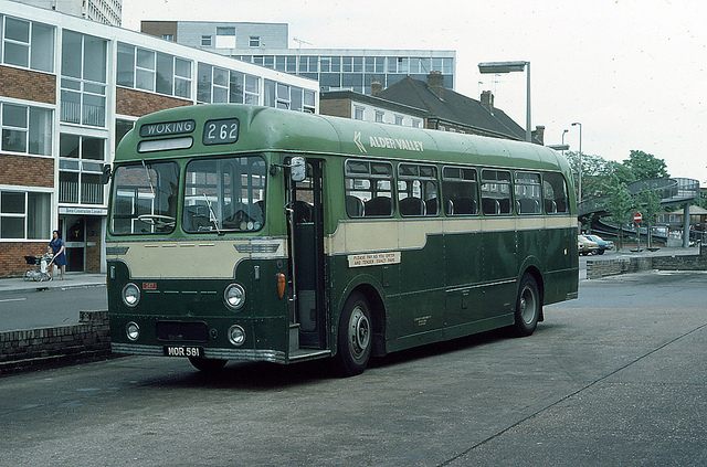 Alder Valley AEC Reliance 347 at Woking in 1976.   Alder Valley was a merger within the National Bus Company of the Thames Valley and Aldershot & District bus companies.   The colour chosen for the vehicles was NBC's poppy red.   Thames Valley's vehicles were Red & Cream,   This is an ex Aldershot 7 District vehicle displaying their Green & Cream livery.