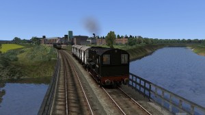 Diesel shunter 13068 crosses the River Nith with a short train of vans from the Carnation Condensed Milk factory visible behind