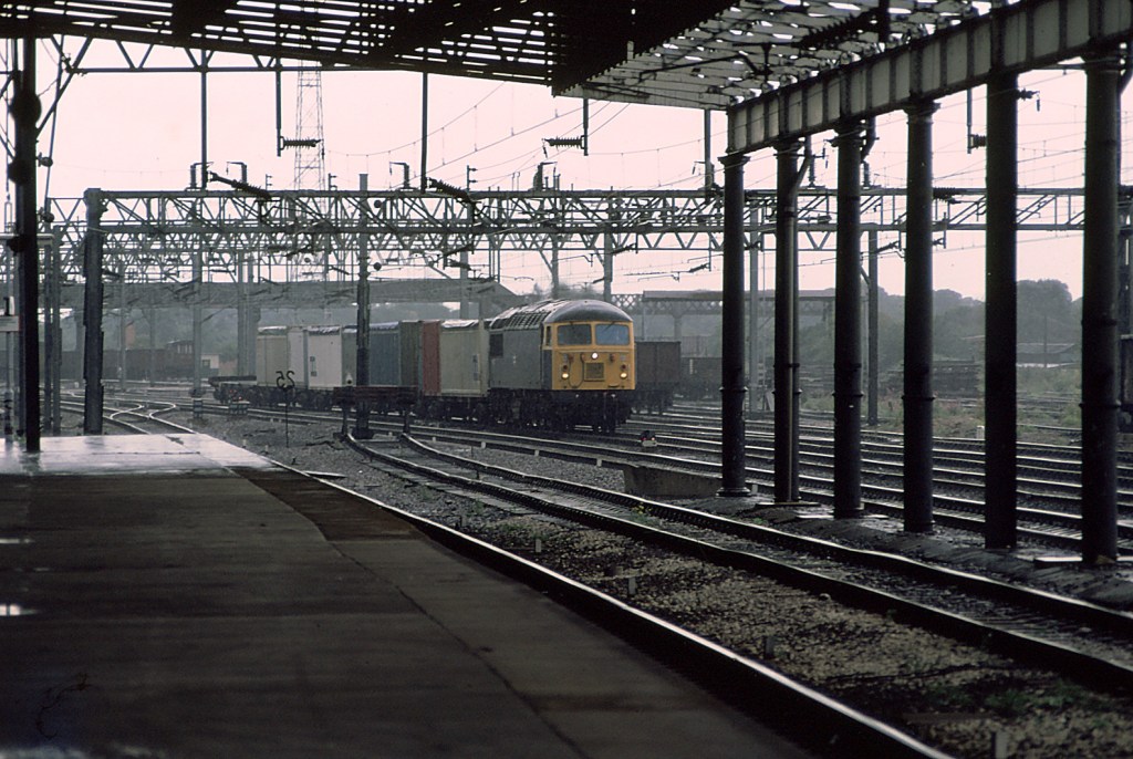 An unidentified member of the class hauls a short intermodal service through Rugby.   The majority of the class were withdrawn in 2004 by EWS following the privatisation of British Railways.   Of the 135 strong class 27 have been scrapped.   A few locomotives have returned to service with other operators both abroad and in the UK.   Many remain in store awaiting their fate.