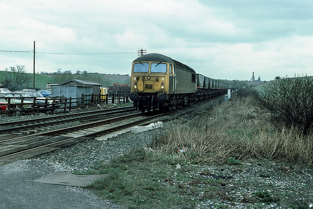 56024 on merry-go-round traffic at Crofton.   The class had been in service for only 8 years when the miners strike of 1984-5 and the subsequent closure of many of Britains coal mines saw them without the work they were designed for.   Sharlston Colliery on the distant horizon closed in 1993 and was reduced to a wasteland.